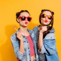 two young women with lollipops