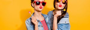 two young women with lollipops